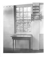SA0648 - Image of a table in front of a window and a small side chair hanging on wall pegs., Winterthur Shaker Photograph and Post Card Collection 1851 to 1921c
